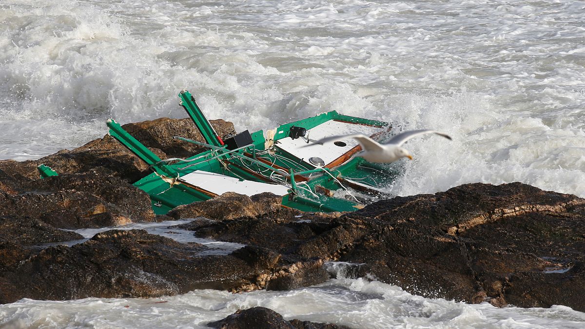 A piece of a capsized sea-rescue boat is seen on rocks during Storm Miguel