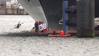 Climate change activists block cruise ship from leaving German harbour