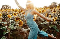 Woman in a jumpsuit, sunflower field