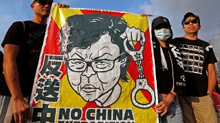 Protesters hold a placard as they attend a demonstration demanding Hong Kong's leaders to step down and withdraw the extradition bill, in Hong Kong, China, June 16, 2019.