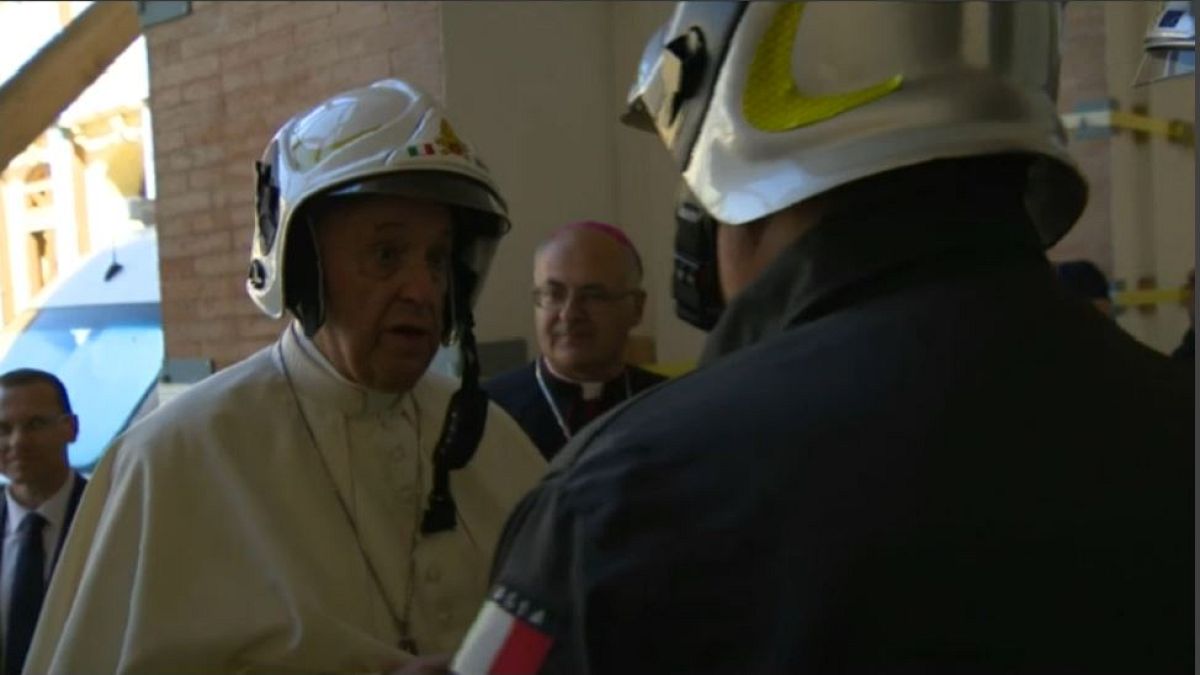 Pope Francis dons fireman's helmet to visit cathedral in Camerino 