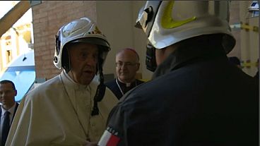 Pope Francis dons fireman's helmet to visit cathedral in Camerino 