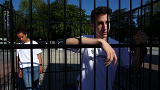 Teenagers in a cage protest the Trump administration's policy of child detention and migrant family separation in Geneva on June 17, 2019.