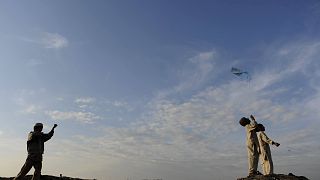 Afghan boys engaging in child play flying kites in Kabul, Afghanistan