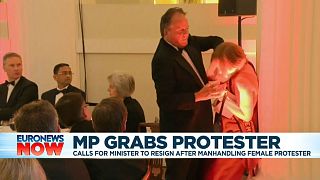 UK junior minister suspended after grappling with eco-protester