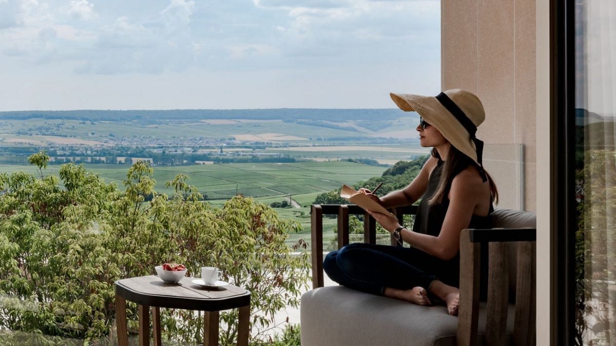 A Woman overlooking vineyards at Royal Champagne Hotel & Spa