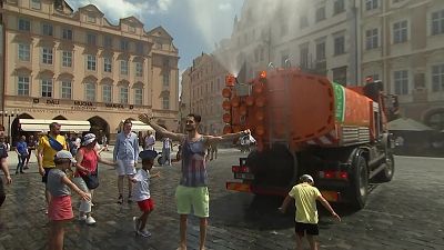 Sprinkler truck sprays people in Prague with water in 37C temperatures