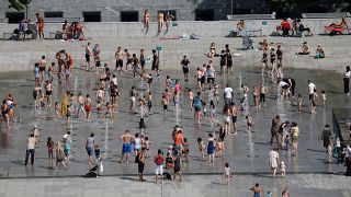 People cool off in the fountains at the Andre Citroen park in Paris as a heatwave hit much of the country, France, June 25, 2019. 