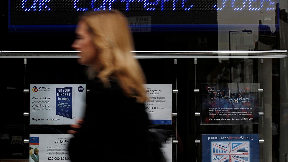  A pedestrian walks past an employment centre in London