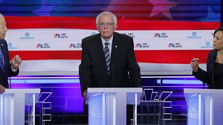 Former Vice President Joe Biden and Senator Kamala Harris debate racial issues as Senator Bernie Sanders listens