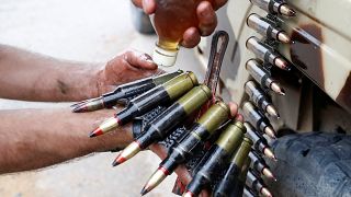 أحد مقاتلي حكومة الوفاق يسكب زيتا على الرصاص خلال المعارك مع قوات المشير خليفة حفتر. أيار/2019