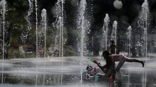  People cool off in a fountain in Nice during a heatwave that has enveloped much of France, June 27, 2019