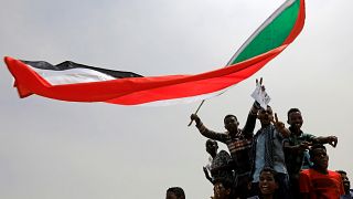 Sudanese shout slogans during a demonstration demanding the ruling military hand over to civilians in Khartoum, Sudan, June 30, 2019. 