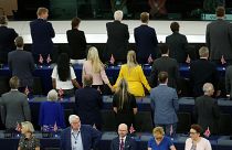Members of the Brexit Party turn their back to the assembly as the European anthem is played, during the first plenary session of the newly elected European Parliament.