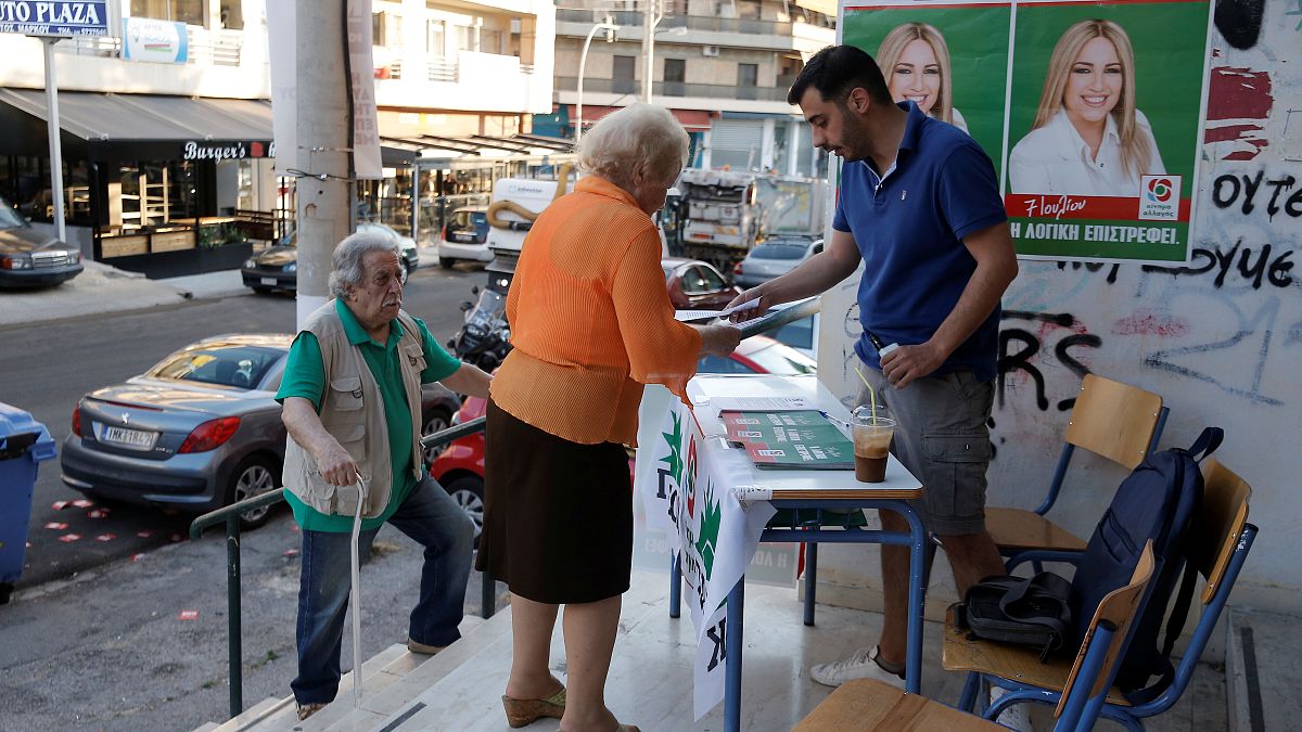 People are seen at a polling station during the general election in Athens, Greece, July 7, 2019. 