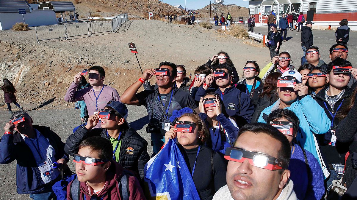 People test their special solar glasses before the solar eclipse in La Silla European Southern Observatory (ESO) at Coquimbo