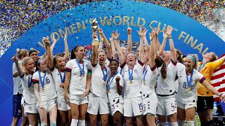 Carli Lloyd of the U.S. and team mates celebrate winning the women's world cup with the trophy.