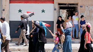 سوريون عائدون إلى مدينتهم القصير يوم الأحد 7 يوليو/تموز