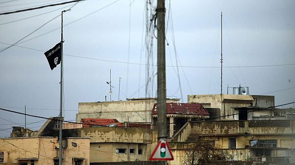 An IS flies in an area of Mosul where fighters are clashing with Iraqi forces.