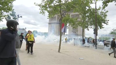French police fire tear gas as protests follow Bastille Day parade