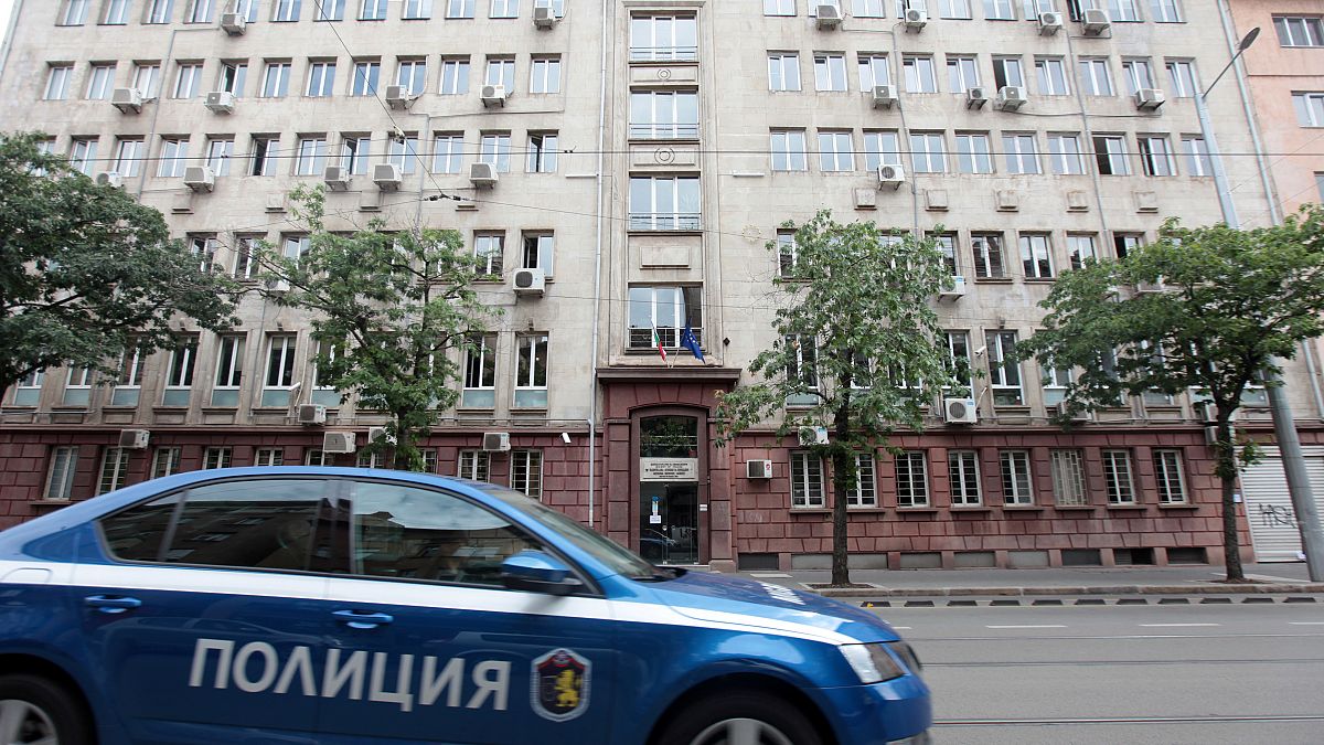 A police car passes past Bulgaria's National Revenue Agency building in Sofia, Bulgaria, July 16, 2019. 