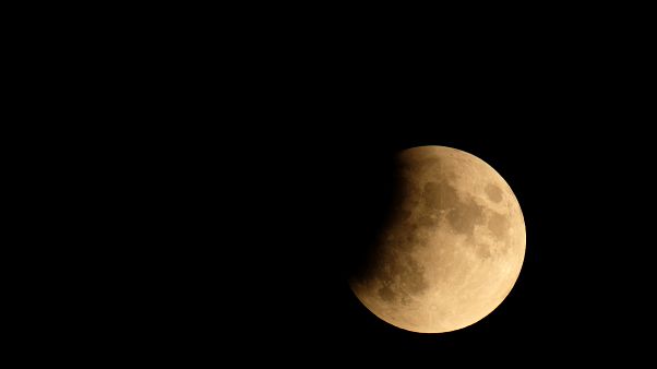The moon is seen during a partial lunar eclipse in Venice, Italy July 16, 2019. The moon is seen during a partial lunar eclipse in Venice, Italy July 16, 2019.