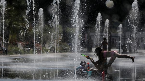 FILE PHOTO: People cool off in a fountain in Nice as a heatwave hits much of the country, France FILE PHOTO: People cool off in a fountain in Nice as a heatwave hits much of the country, France