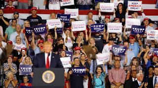 Crowd chants 'send her back' at rally after Trump accused of racism