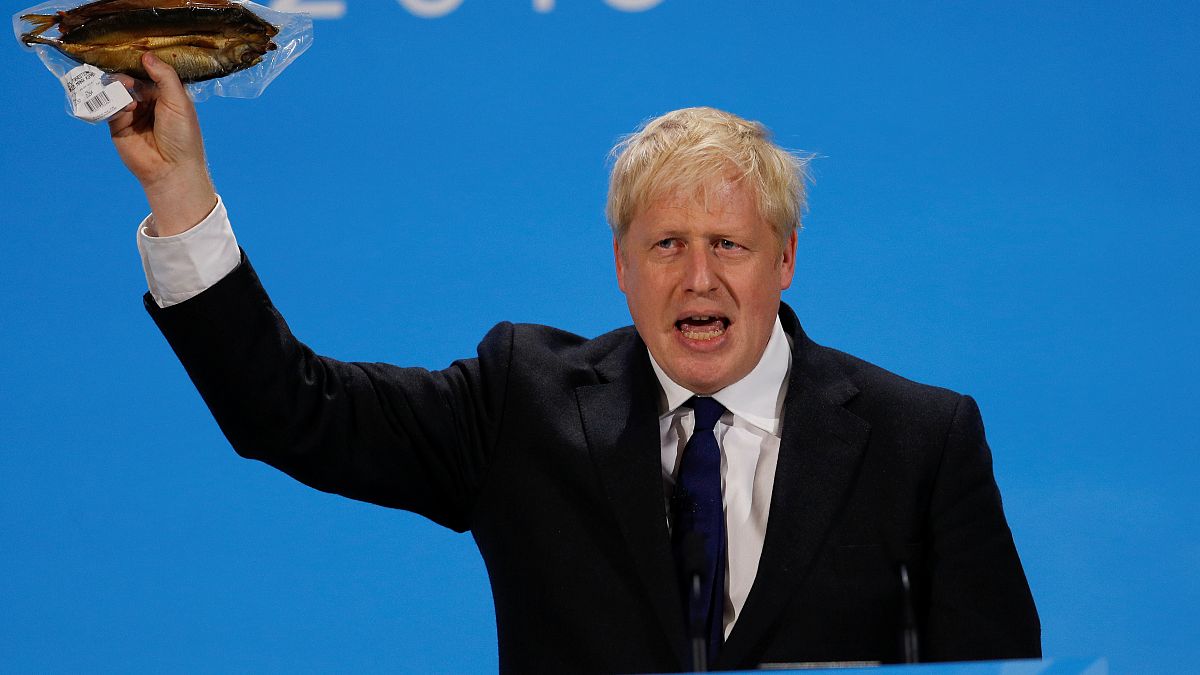 Boris Johnson holds a plastic wrapped kipper fish during a hustings event in London, Britain July 17, 2019