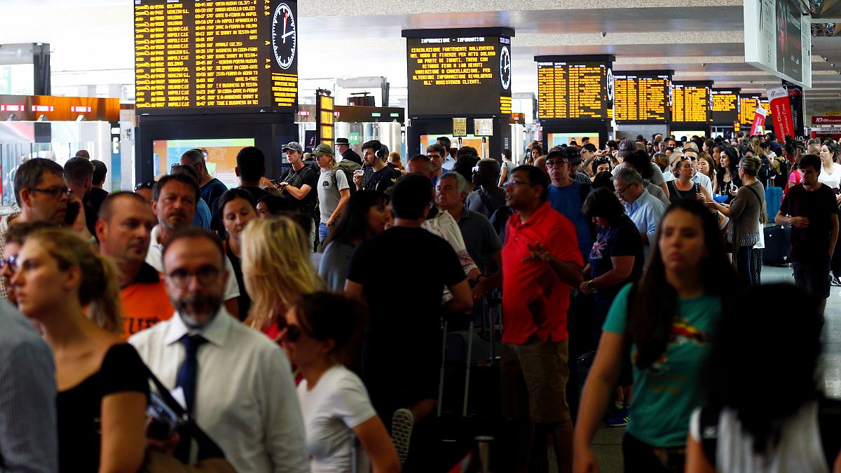 Passengers waiting at Termini station in Rome, after a fire hit the infrastructure around Florence