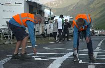 Watch: Tour de France employs men to redesign the phallic graffiti on the route