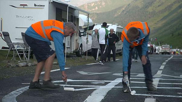 Watch: Tour de France employs men to redesign the phallic graffiti on the route Watch: Tour de France employs men to redesign the phallic graffiti on the route