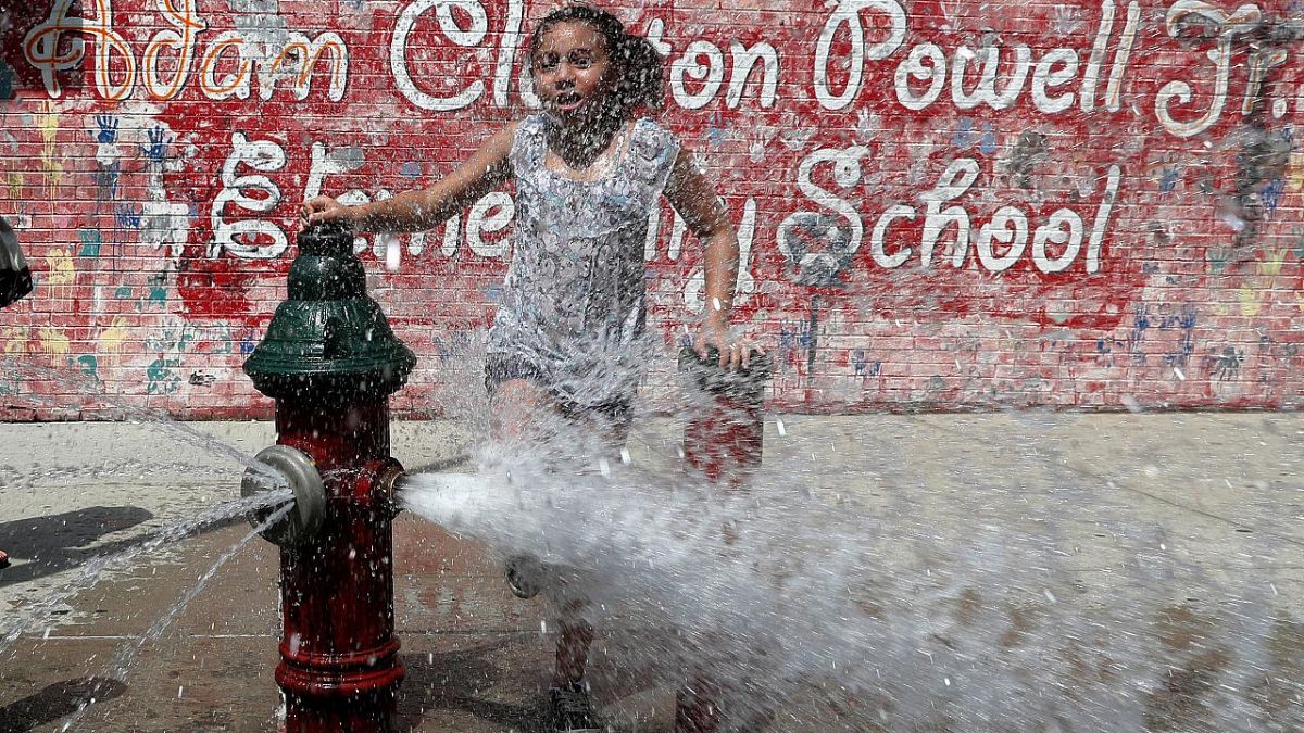 A girl cools off in Washington Heights in Manhattan during a July 2019 heat wave