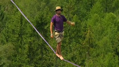 Thrill-seekers balance on slacklines in Czech forest