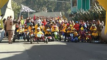 Families enjoy a bout of box cart racing in La Paz