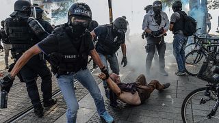 Anti-criminality brigade (BAC) police officers arrest a man during a gathering in Nantes