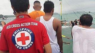 Philippine Red Cross personnel oversee a rescue operation on one of the capsized ferries in the central Philippines, August 3, 2019. 
