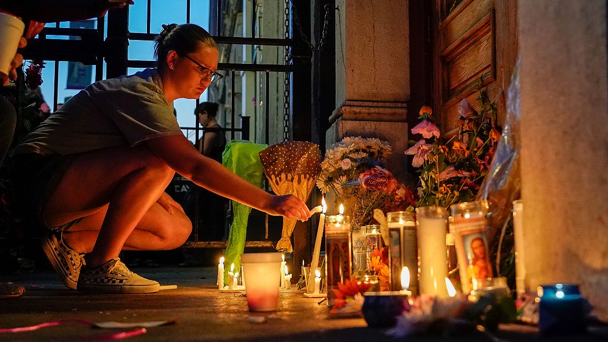 A mourner lights a candle at a memorial during a vigil at the scene of a mass shooting in Dayton, Ohio, U.S. August 4, 2019.