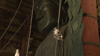 Watch: Worshippers dust the statue of Buddha ahead of festival