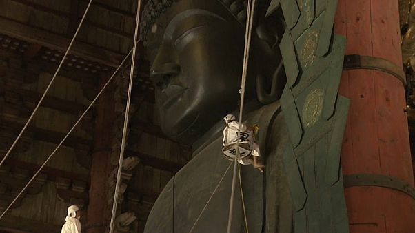 Watch: Worshippers dust the statue of Buddha ahead of festival Watch: Worshippers dust the statue of Buddha ahead of festival