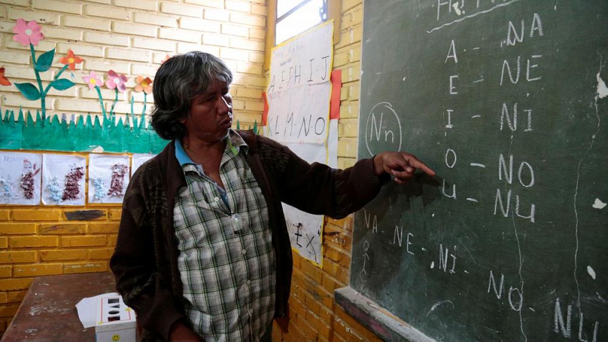 Professor Blas Duarte shows letters in the Maka language, in Mariano Roque Alonso, Paraguay