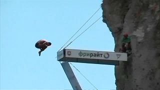 Divers compete in jumping off 27-metre cliff platform in Crimea