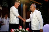 David Cutter and Juan Gonzalez Escalona shake hands after signing a joint venture to market Santiago de Cuba rum
