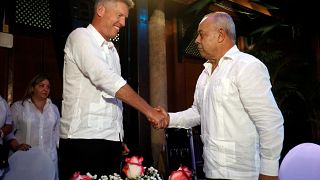 David Cutter and Juan Gonzalez Escalona shake hands after signing a joint venture to market Santiago de Cuba rum