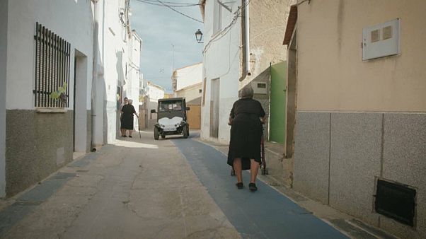 Elderly woman walks along a purpose-built non-slip path Elderly woman walks along a purpose-built non-slip path