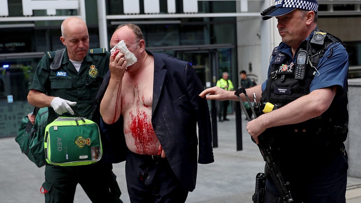 The injured man is helped by medics at the Home Office in London.