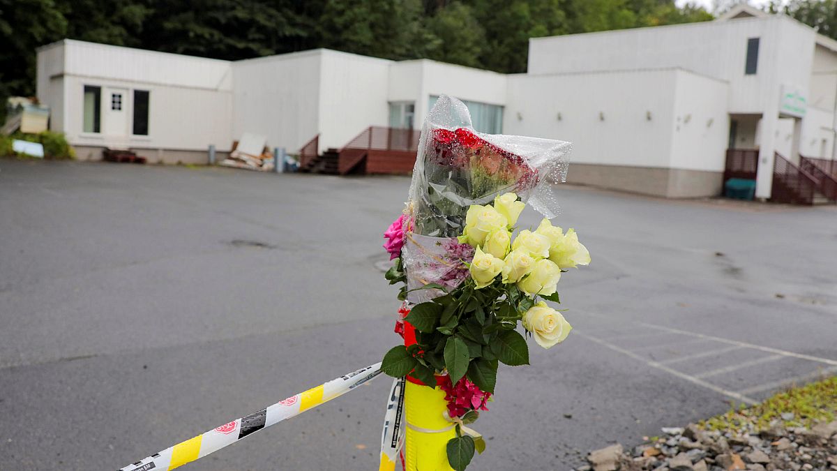 Flowers and a police tape are seem outside Al-Noor Islamic Centre Mosque, a day after a gunman's attack, in Baerum outside Oslo, Norway, 12 August, 2019.