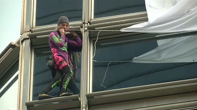 'French Spider-Man' Alain Robert climbs Hong Kong skyscraper and unveils peace banner