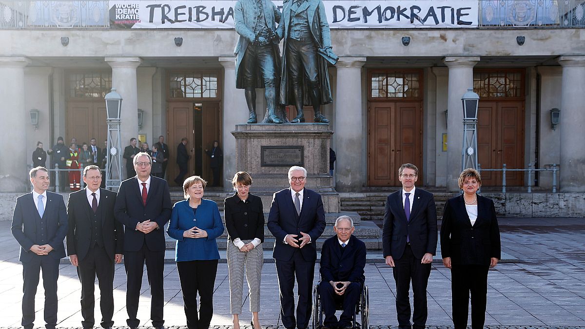 German Chancellor Angela Merkel and President Frank-Walker Steinmeier pose with other dignitaries at an event to mark 100 years since the Weimar constitution was signed in 191