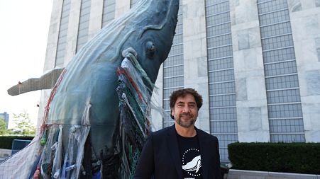 Javier Bardem posed next to the a 19ft tall sculpture representing threats to marine life